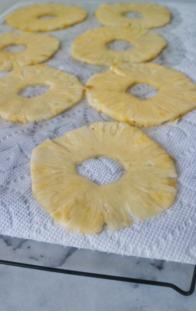 sliced pineapple drying on paper towels