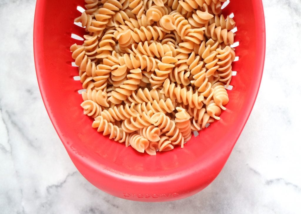 Whole wheat rotini in red colander