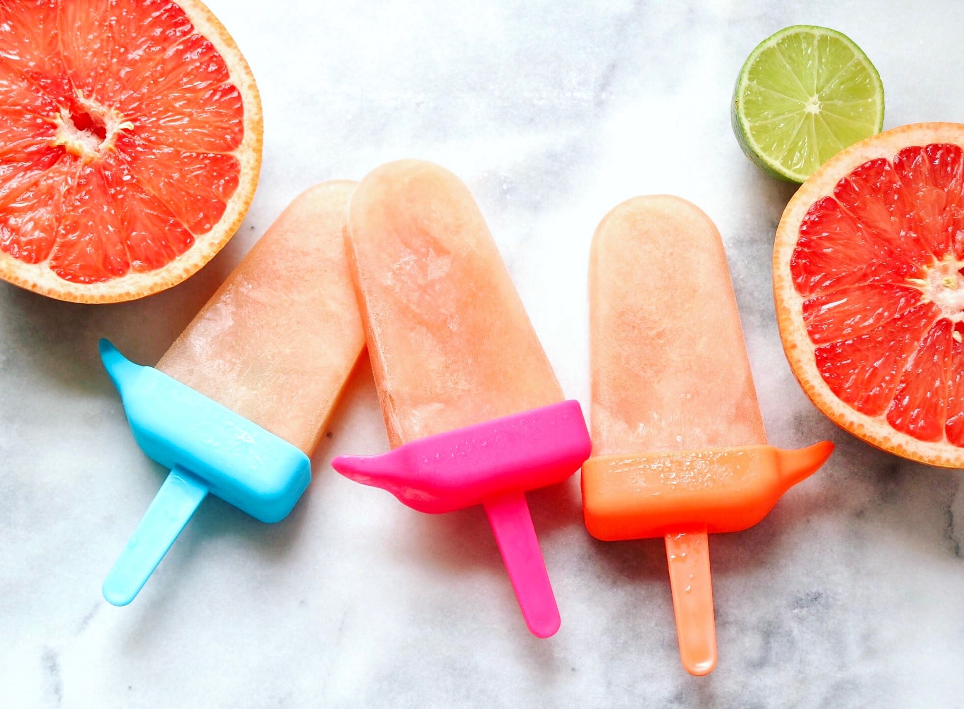 Paloma Popsicles surrounded with fresh grapefruit and limes | The Nutrition Adventure