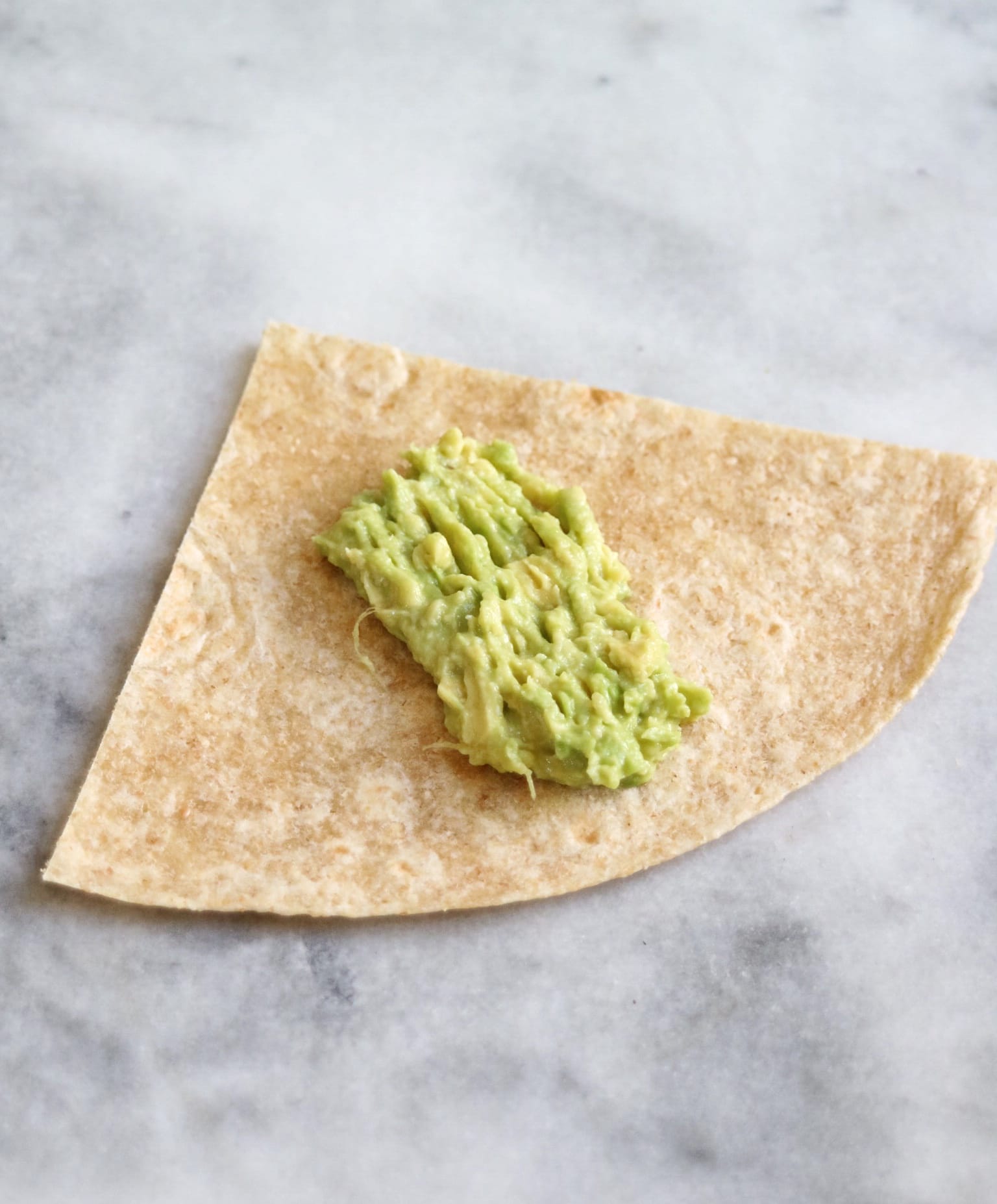 tortilla quarter with mashed avocado on top | The Nutrition Adventure