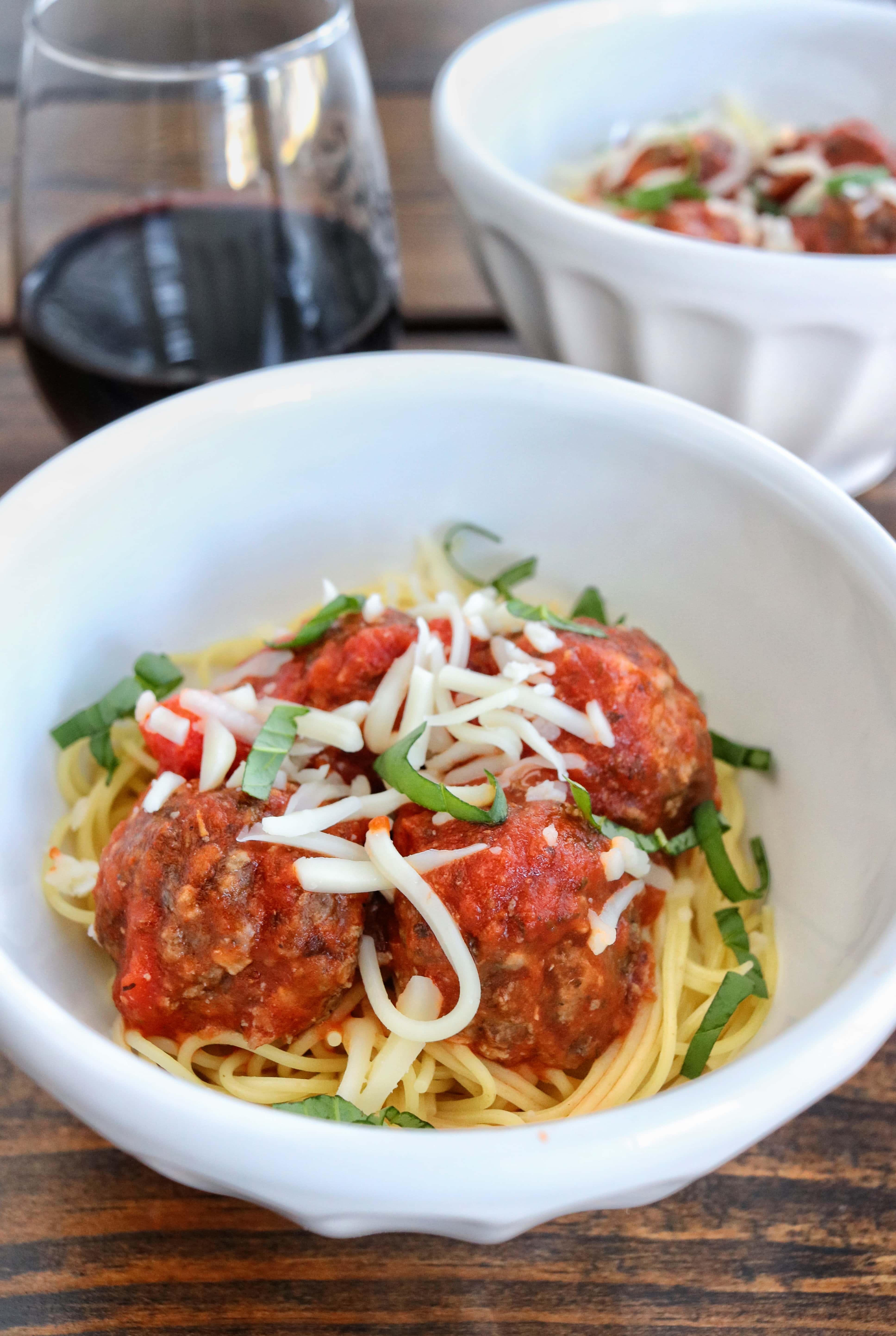 Best Baked Meatballs with spaghetti, topped with shredded mozzarella cheese and fresh basil| The Nutrition Adventure