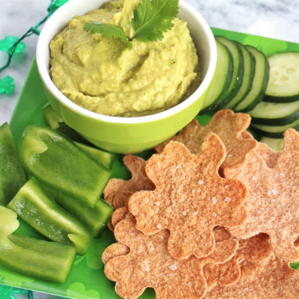 Avocado Hummus with Homemade Tortilla Chips, sliced cucumber, and green bell pepper for dipping